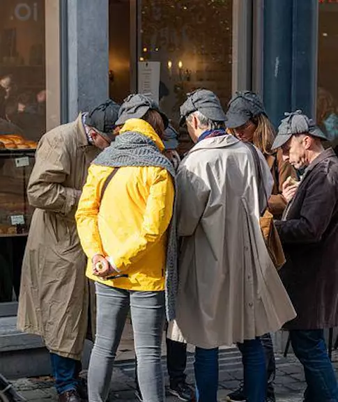 A group of people searching outside during a scavenger hunt activity